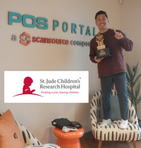 Kevin Nguyen posing with the Datacap Fantasy Football League trophy